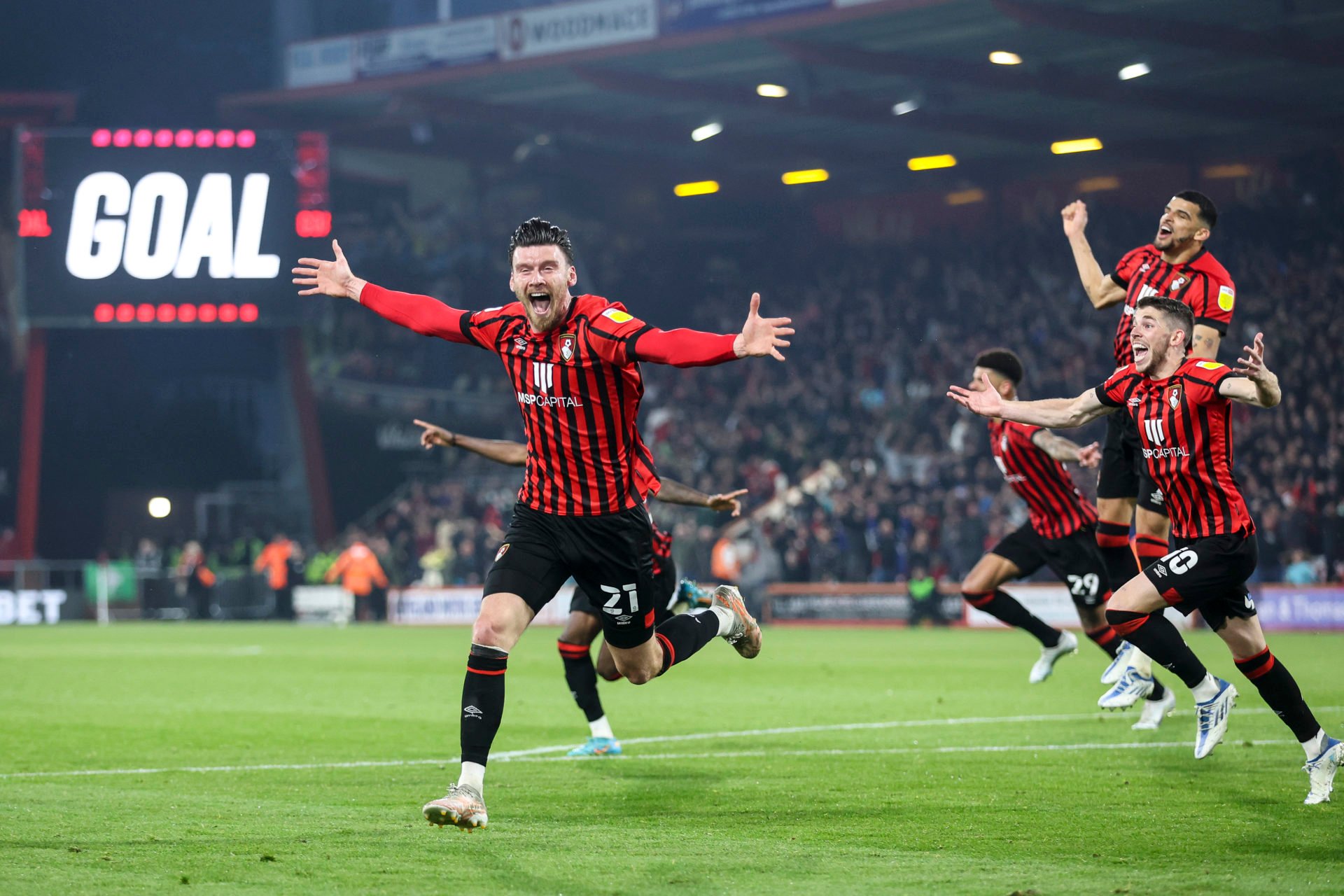  Kieffer Moore, a 6'5" striker from Wales, celebrates scoring a goal for his club, AFC Bournemouth.